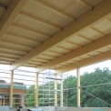 Nejvyšší část střešní roviny je navržena s nosným dřevěným konstrukčním systémem s lepenými vazníky